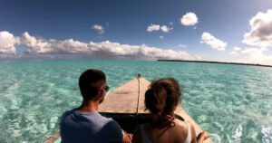 a couple in a boat on a lagoon in french a couple in a boat on a lagoon in french